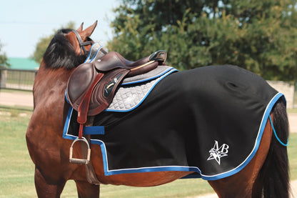 A custom quarter sheet in black with blue trim, featuring a MBS logo, draped over a horse.